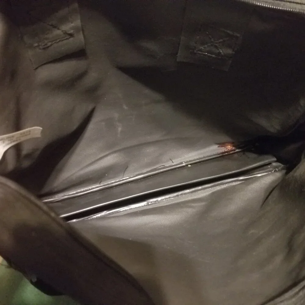 large black bag with straps, and ink-stained interior